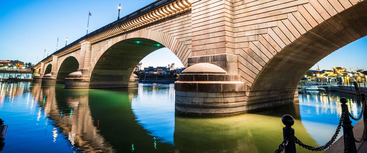 A stone bridge with multiple arches over a body of water.