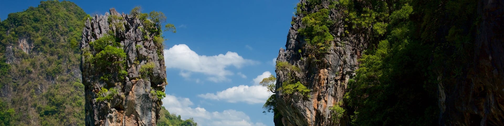 Phang Nga which includes rugged coastline, a bay or harbor and swimming