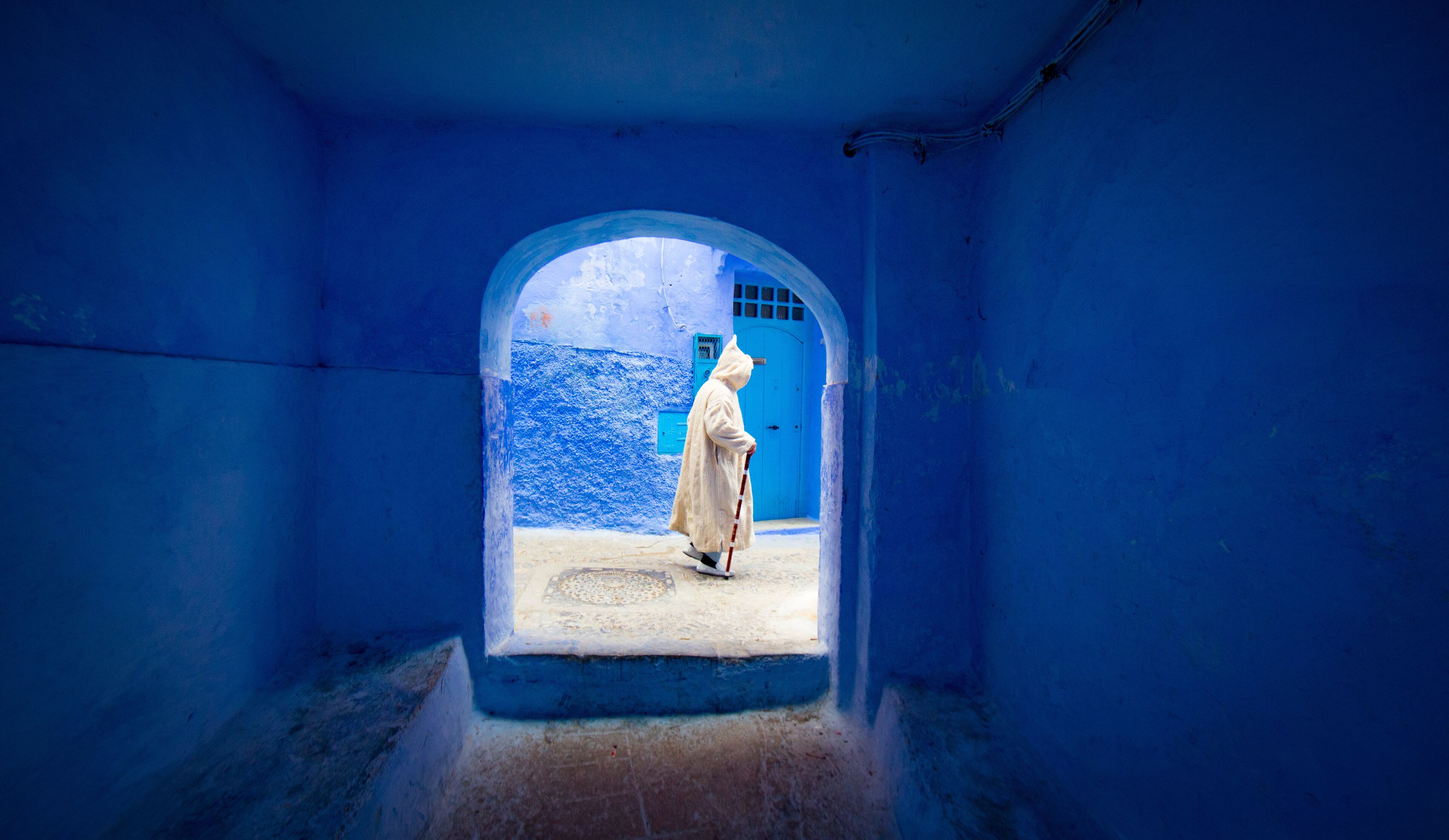 man walking in a street in Chefchaouen, Morocco