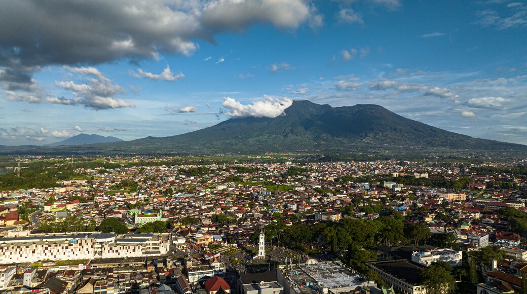 The city of Bukittinggi and Mount Marapi. A clock tower Jam Gadang. Sumatra. Indonesia.