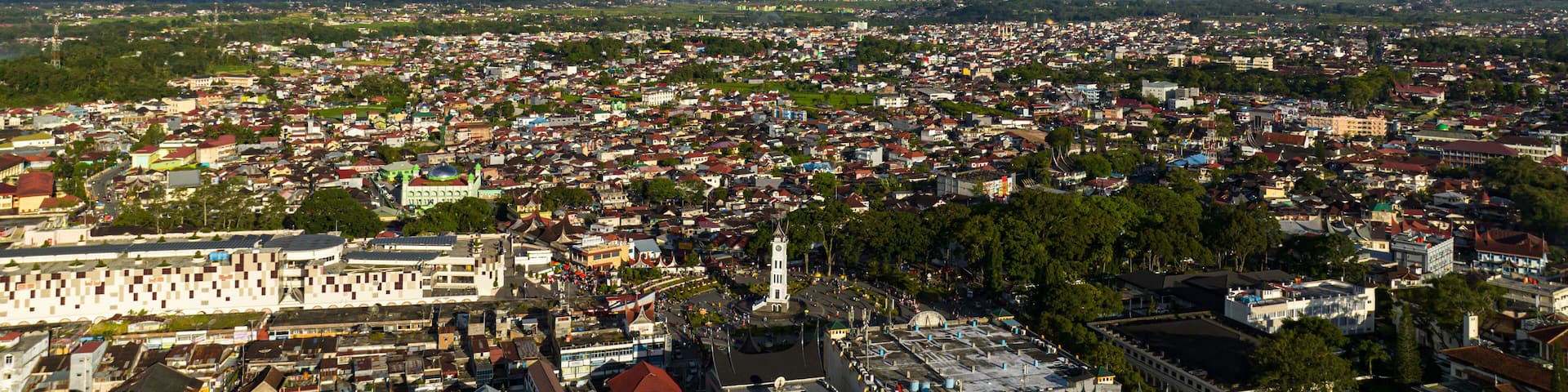 The city of Bukittinggi and Mount Marapi. A clock tower Jam Gadang. Sumatra. Indonesia.