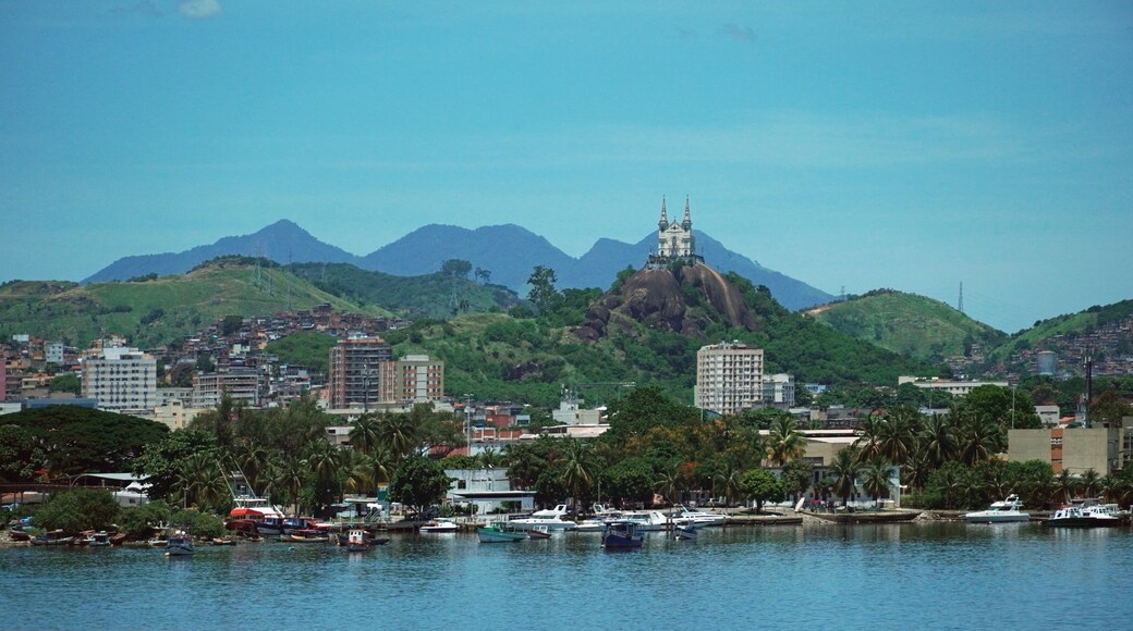 Piscinão de Ramos, located in the Ramos neighborhood in Rio de Janeiro, with some fishing boats and in the background the church of Penha