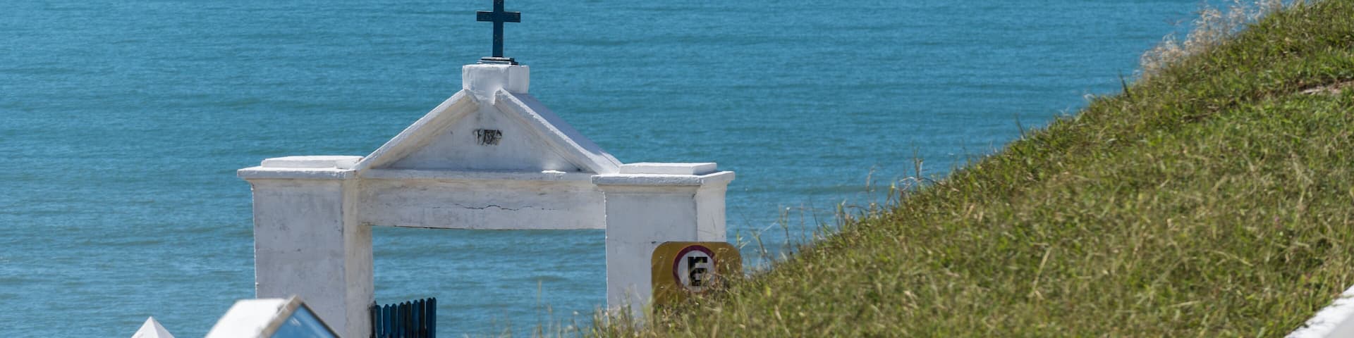 Sunny Day at Itaúna Beach, Saquarema in Rio de Janeiro, Brazil. Famous for waves and surfing. Church and cemetery on top of the hill.