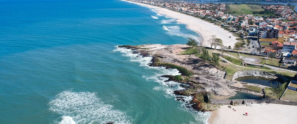 Aerial view of Saquarema and Itaúna beach in Rio de Janeiro. Famous for the waves and the church on top of the hill. Sunny day. drone photo.