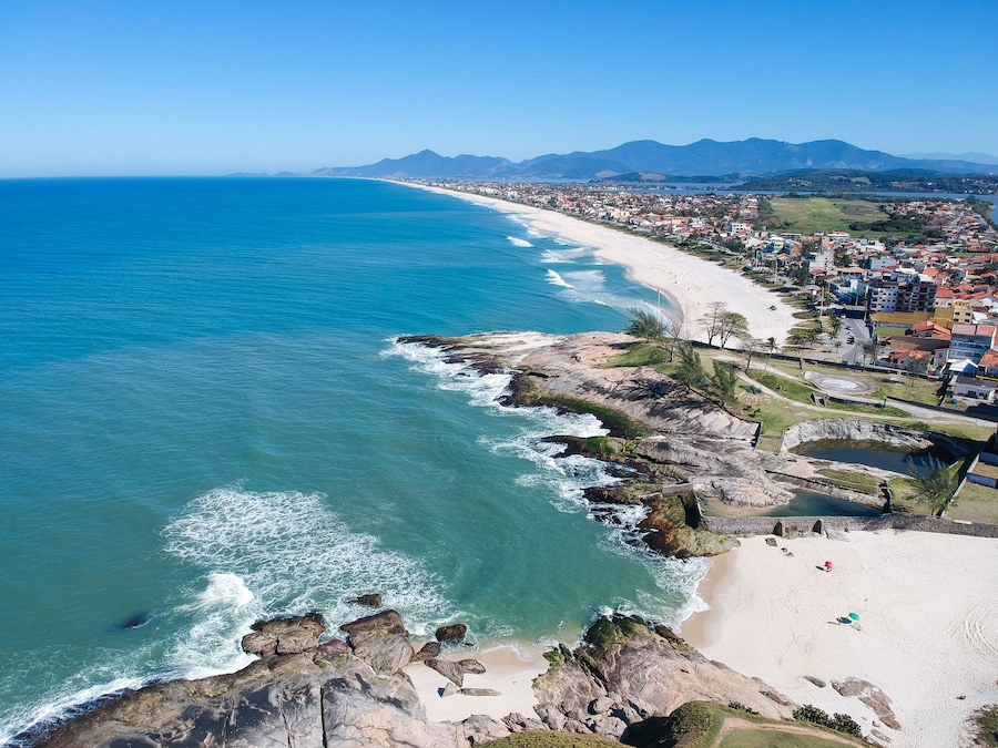 Aerial view of Saquarema and Itaúna beach in Rio de Janeiro. Famous for the waves and the church on top of the hill. Sunny day. drone photo.