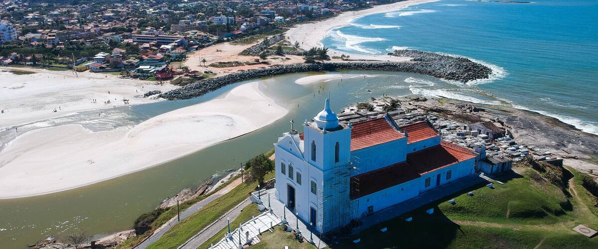 Aerial view of Saquarema and Itaúna beach in Rio de Janeiro. Famous for the waves and the church on top of the hill. Sunny day. drone photo.