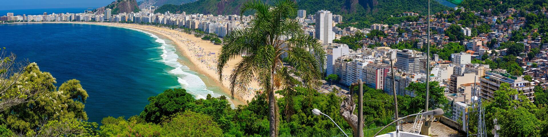Copacabana beach in Rio de Janeiro, Brazil. Copacabana beach is the most famous beach of Rio de Janeiro, Brazil. Skyline of Rio de Janeiro with flag of Brazil