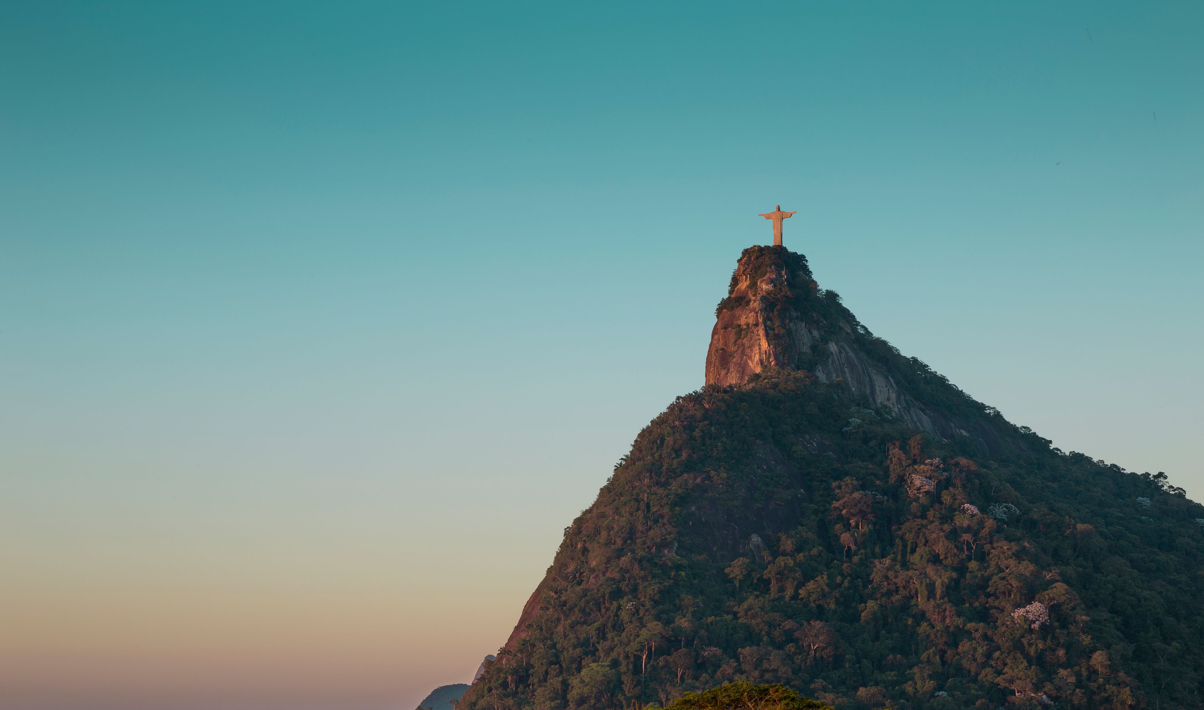 A mountain with a cross at its peak.