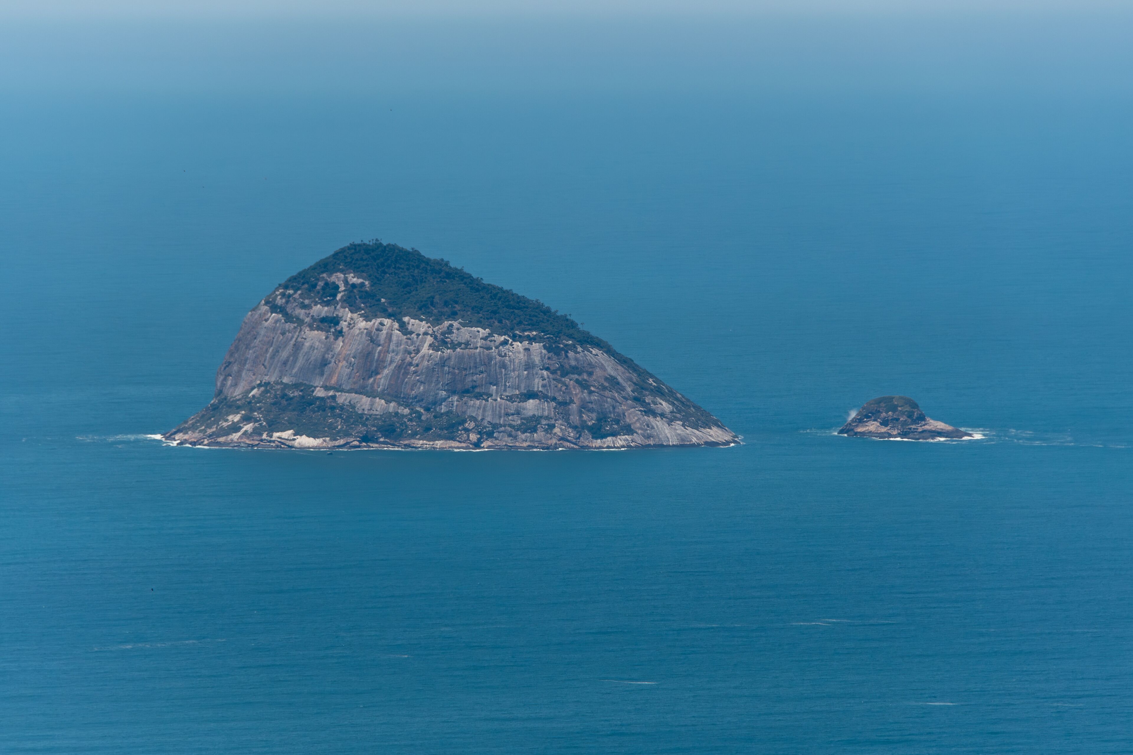 A large island with a prominent peak and a smaller island nearby.