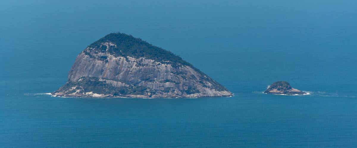 A large island with a prominent peak and a smaller island nearby.