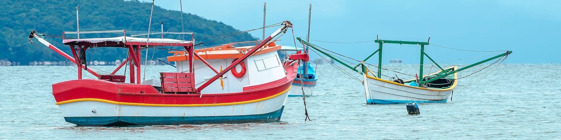 Fishing boats anchored on the sea. Boats at Bombinhas, Praia de Zimbros beach.