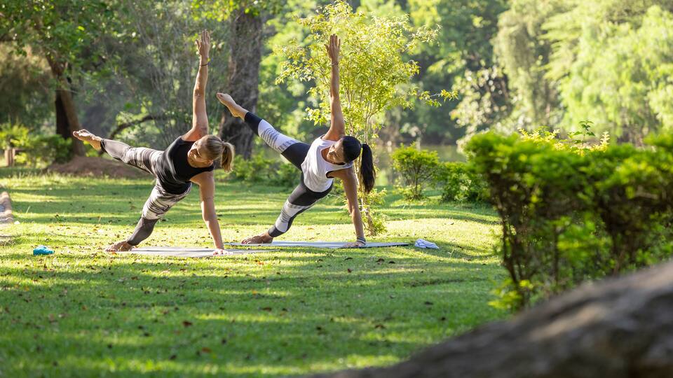 two women practicing yoga in a park, Barueri, São Paulo, Brazil