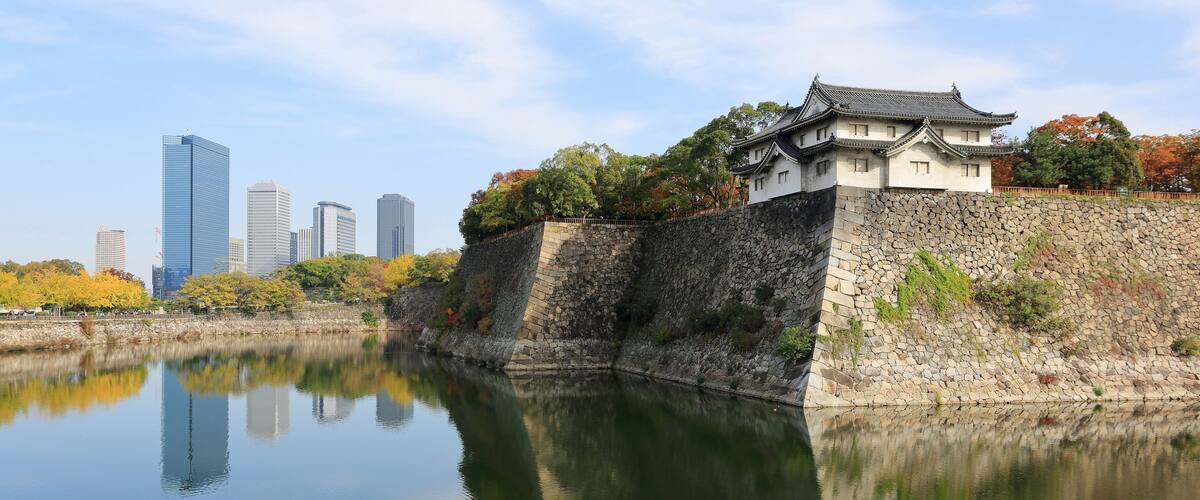 Inui-yagura Turret, guarding the outer moat of Osaka Castle and the skyline of Osaka Business Park, Osaka, Japan.