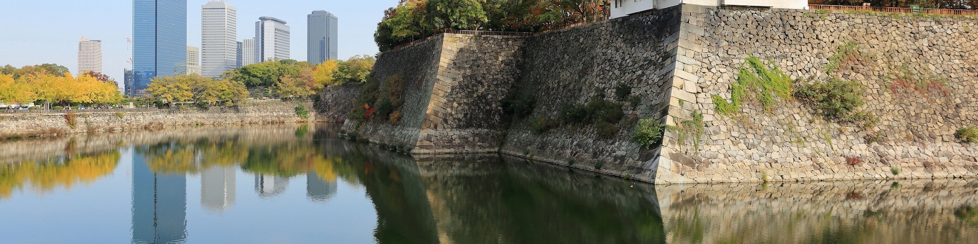 Inui-yagura Turret, guarding the outer moat of Osaka Castle and the skyline of Osaka Business Park, Osaka, Japan.