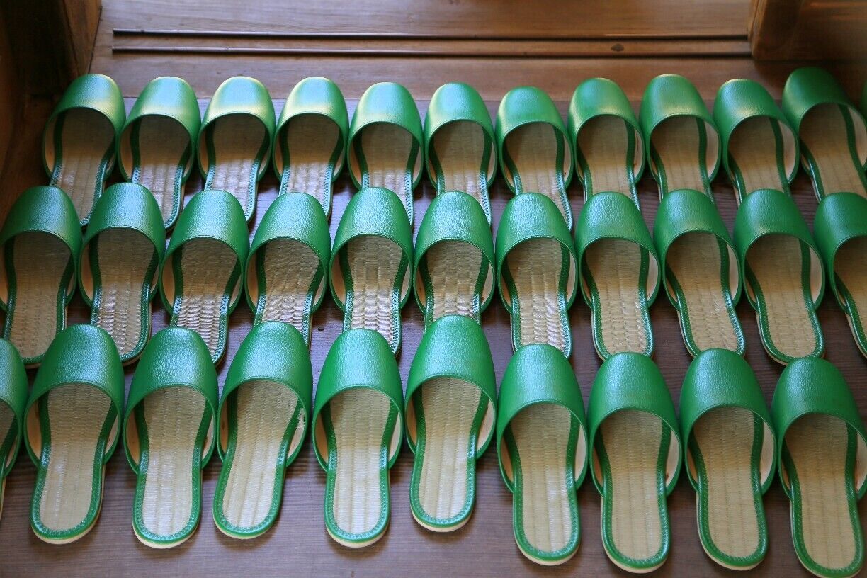 A sea of bright green slippers welcoming guests at Jimyoin Temple in Koyasan, Japan