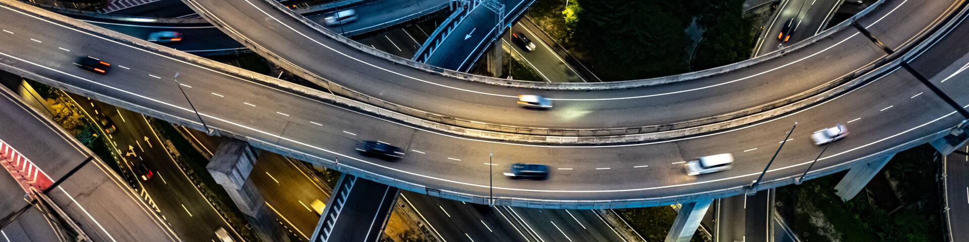 A complex network of multi-level highways with vehicles in motion.