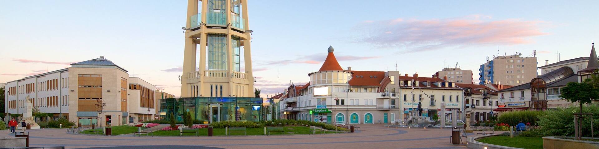 A tower with a unique design, surrounded by historic buildings and a public square.