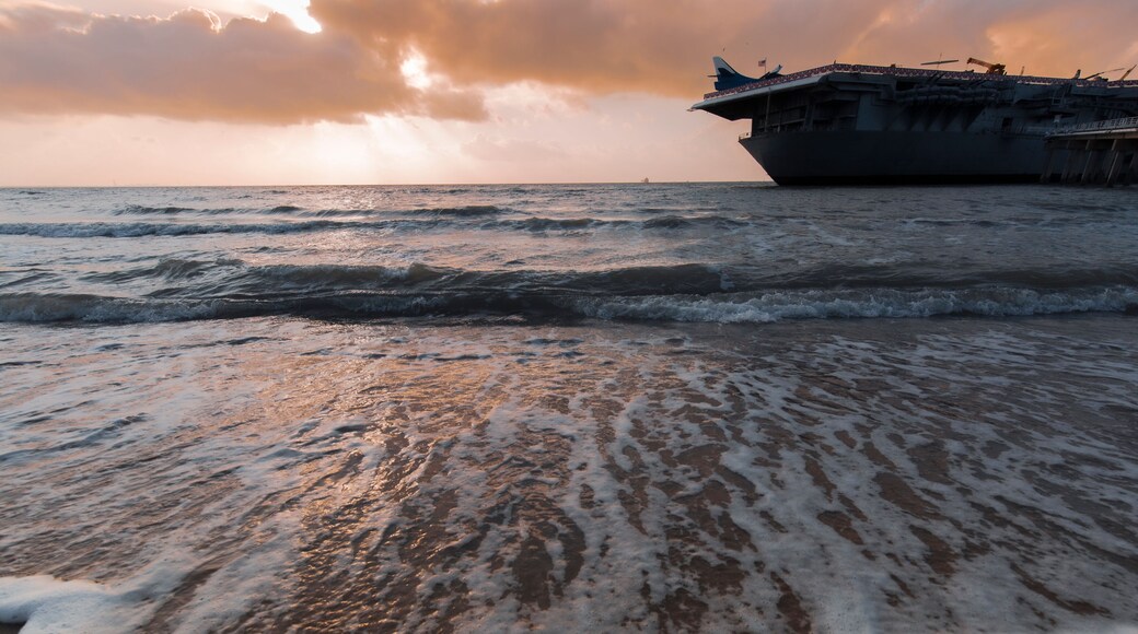 sunset ,North Beach in Corpus Christi, Texas, USA with aircraft carrier ship