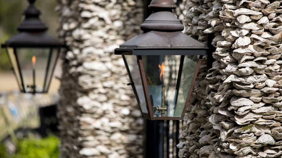 Architectural detail of gas lamps on oyster shell wall in South Carolina.
