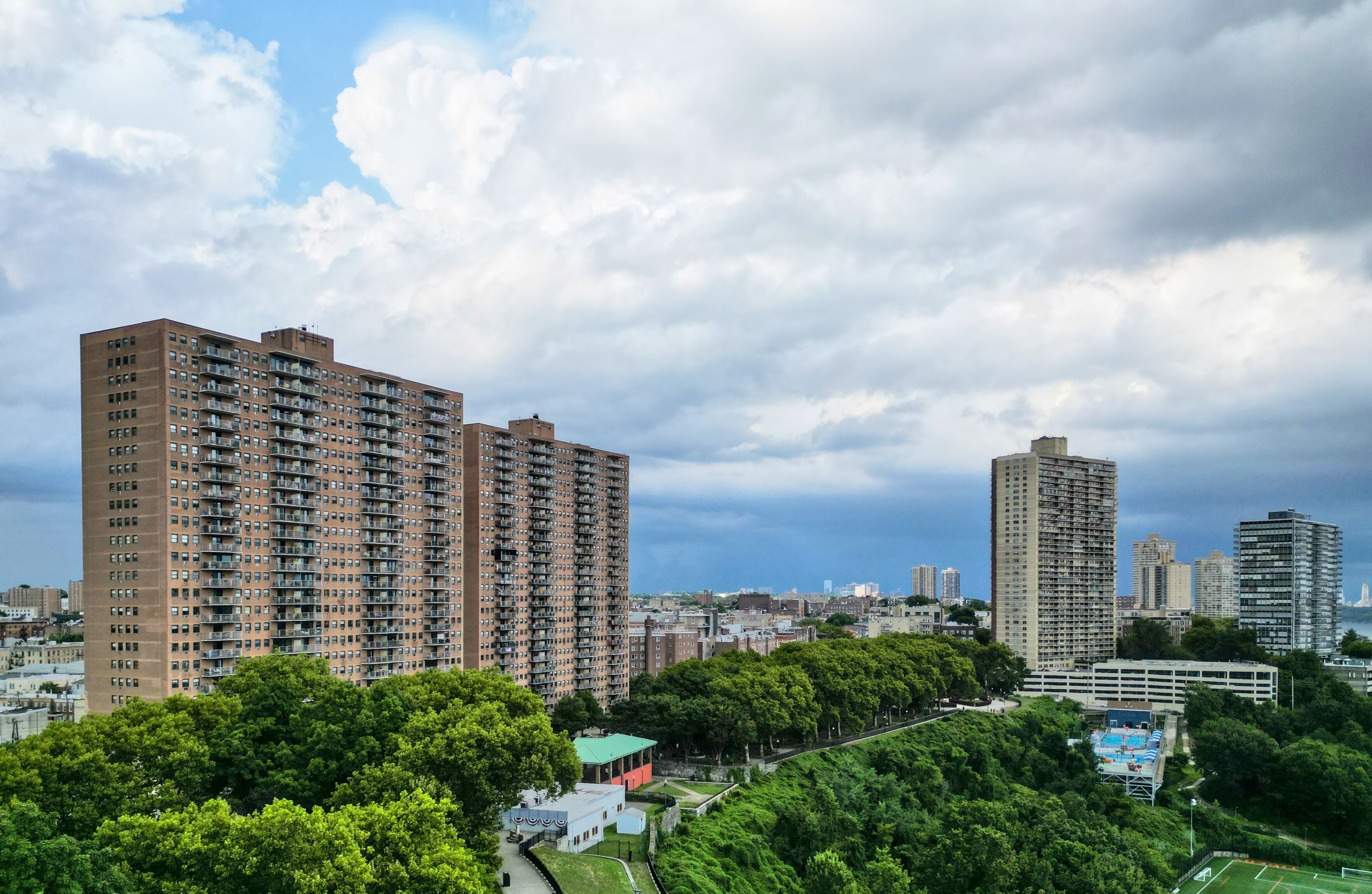 tall apartment buildings with balconies overlooking manhattan new york (west weehawken jersey city hoboken) ny nj housing real estate residential tower living rent skyline