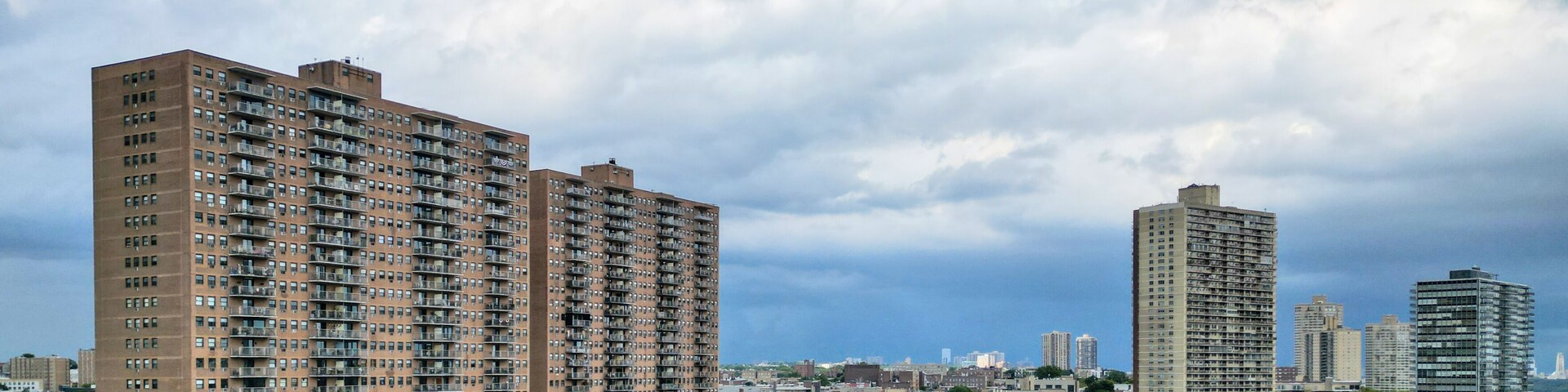 tall apartment buildings with balconies overlooking manhattan new york (west weehawken jersey city hoboken) ny nj housing real estate residential tower living rent skyline