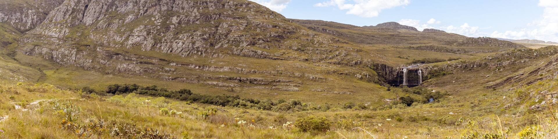 A mountainous landscape with a waterfall.