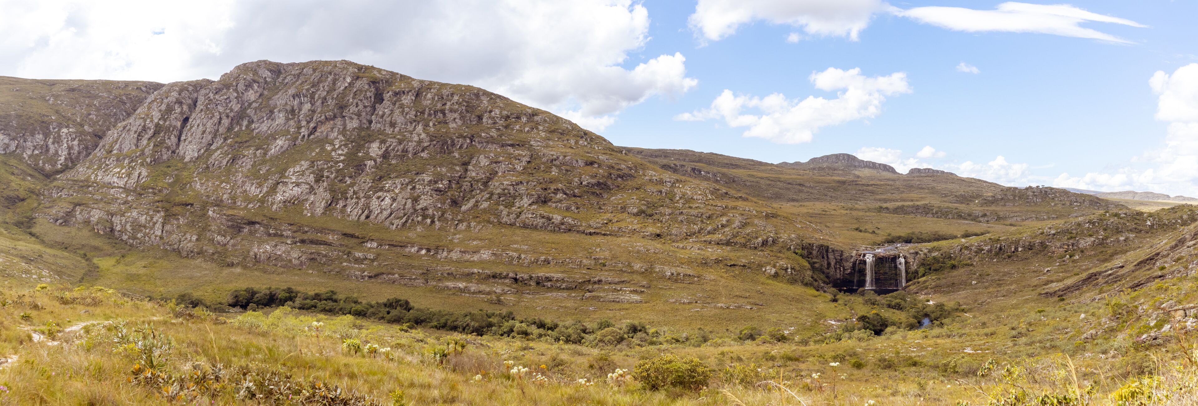 A mountainous landscape with a waterfall.