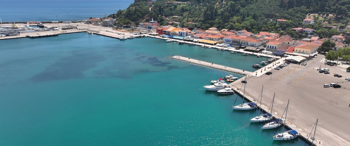 A coastal town with a marina, boats, and a beach.