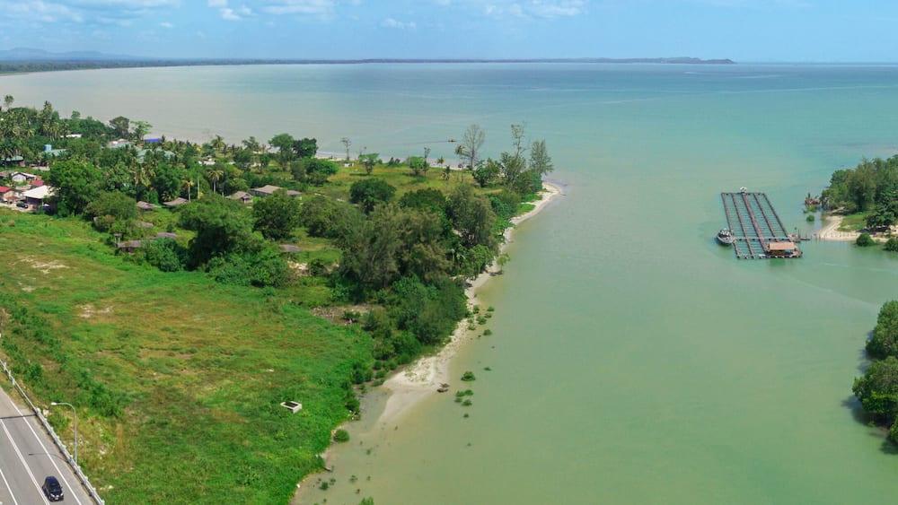 A coastal landscape with a bridge, a road, and a river.
