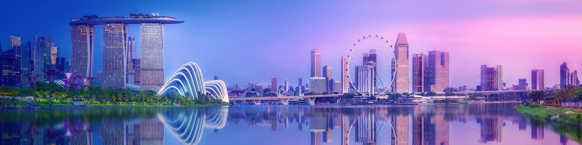 A city skyline with modern architecture, including a distinctive bridge and a large Ferris wheel.