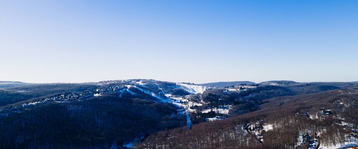 A snow-covered mountain landscape with a clear blue sky.