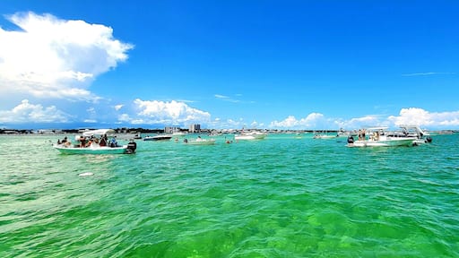 Boats anchored and Beached on a Sandbar, People Enjoying a Beautiful Summer Day Anchored on the Sandbar in the Turquoise Water by Perdido Pass while at Robinson Island in Orange Beach, Alabama