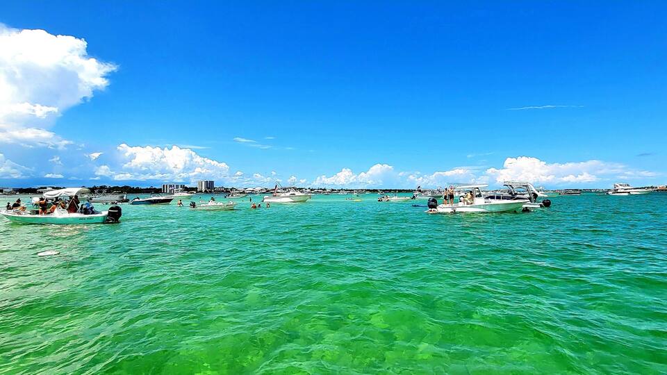 A marina with several boats docked and people on the water.