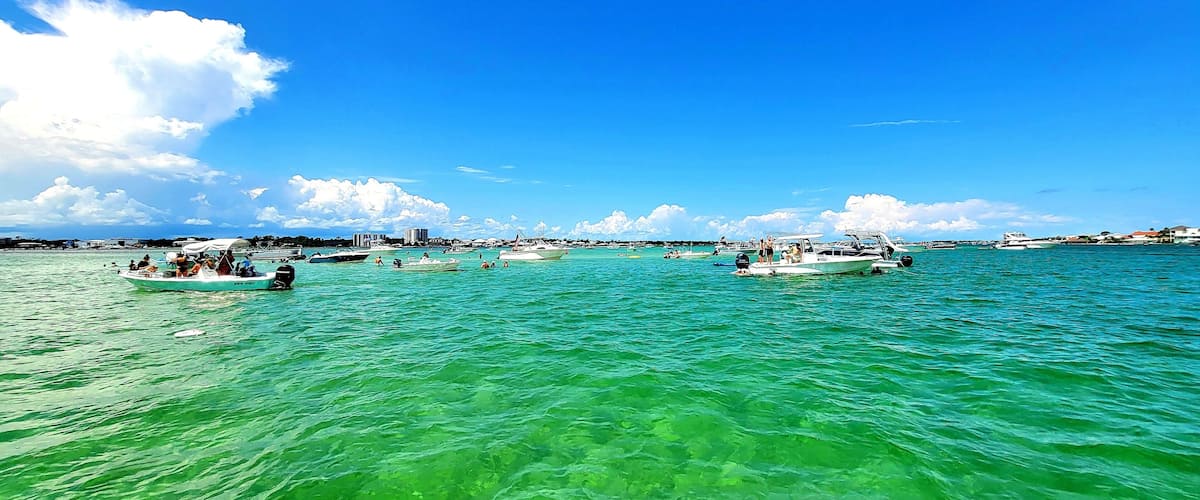 A marina with several boats docked and people on the water.
