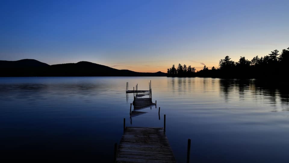 Silhouette Of Whiteface Mountain With Flooded Dock On Silver Lake