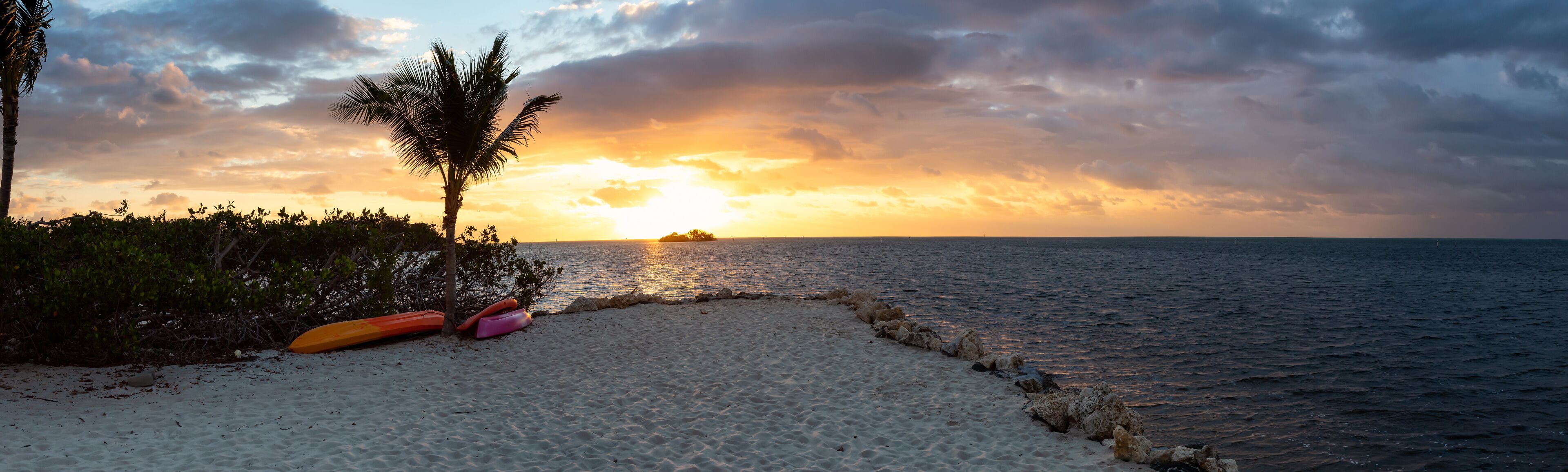 Striking sunrise viewed on a tropical sandy beach at the Atlantic Ocean Shore. Plantation Key, Florida Keys, Florida, United States.