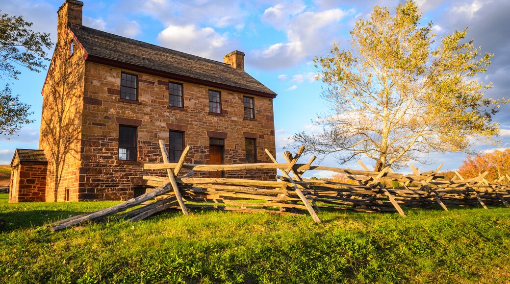 A stone building with a wooden fence in front.