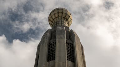 A tall, cylindrical structure with a spherical top and a grid-like pattern on the upper part.