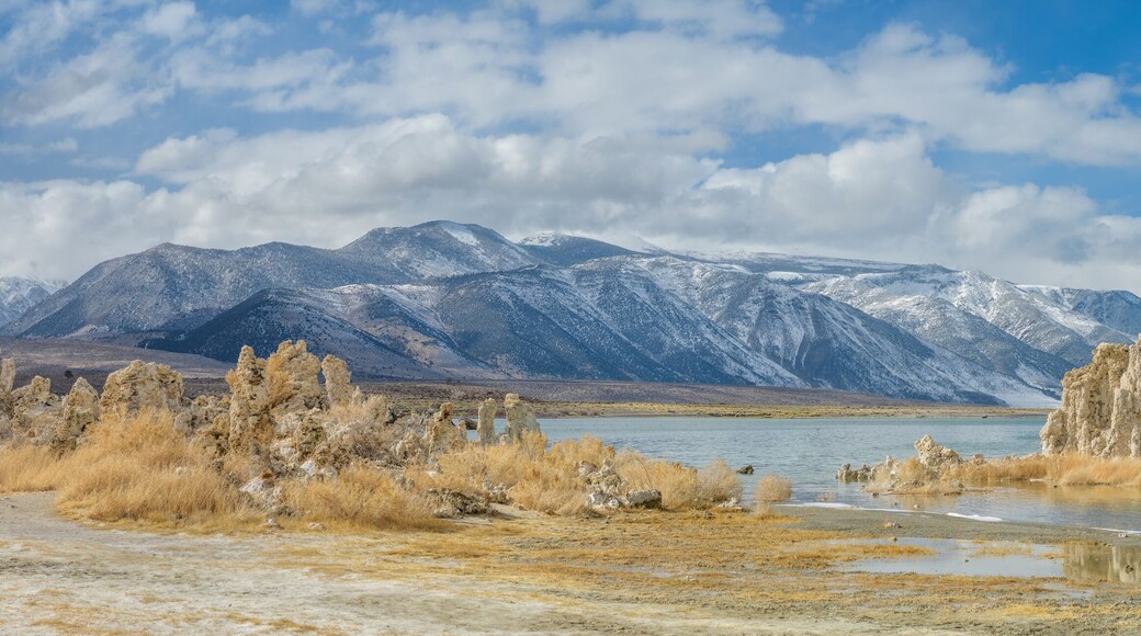 Panoramic view with mounds of the natural formation of tufa (calcium carbonate) at Mono Lake with the Sierra Nevada mountains in California, USA.