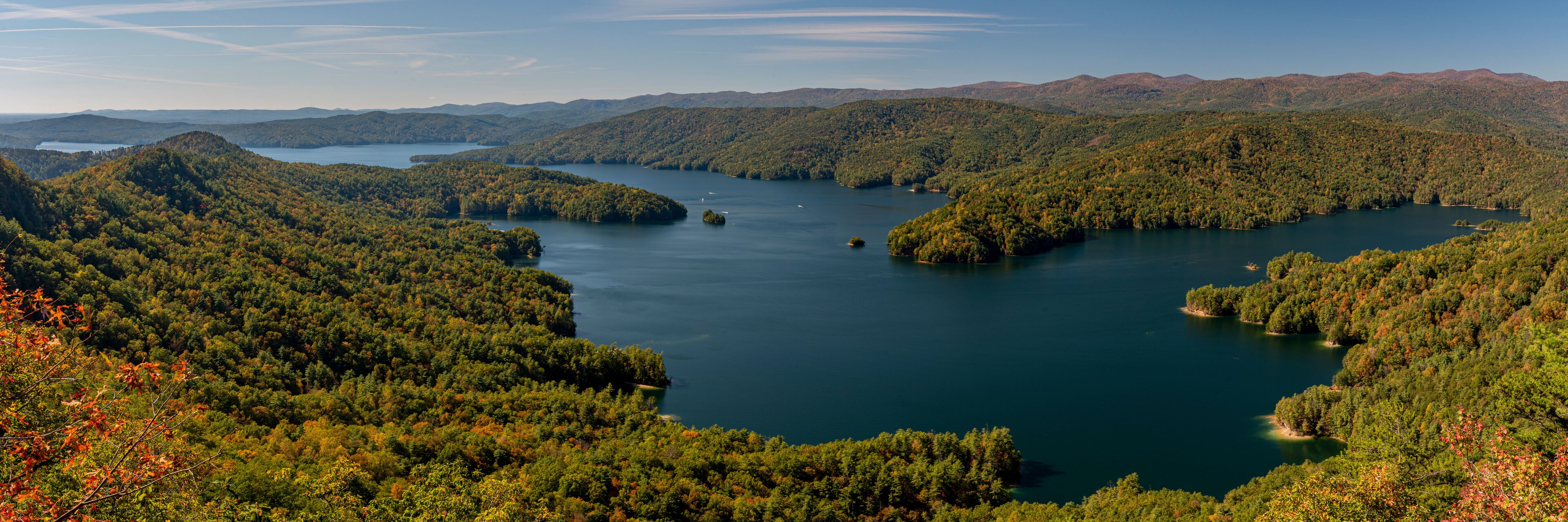 A lake surrounded by forested hills.