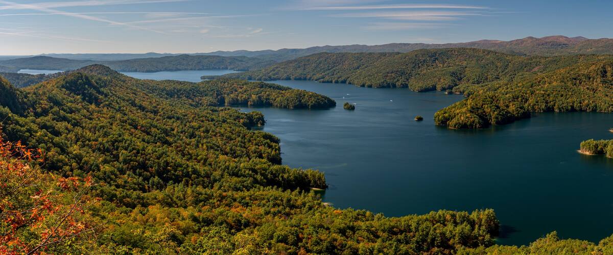 A lake surrounded by forested hills.