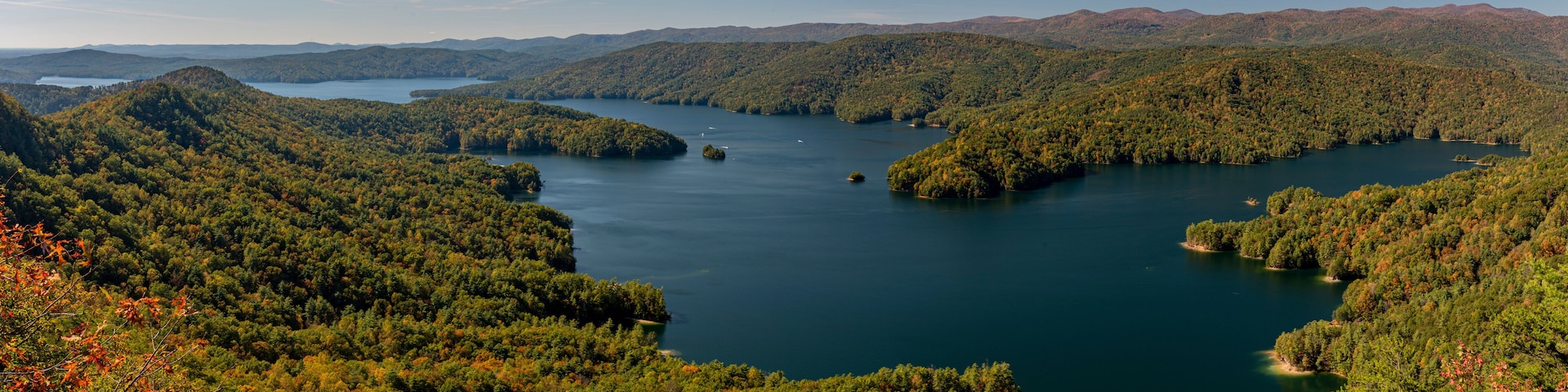 A lake surrounded by forested hills.