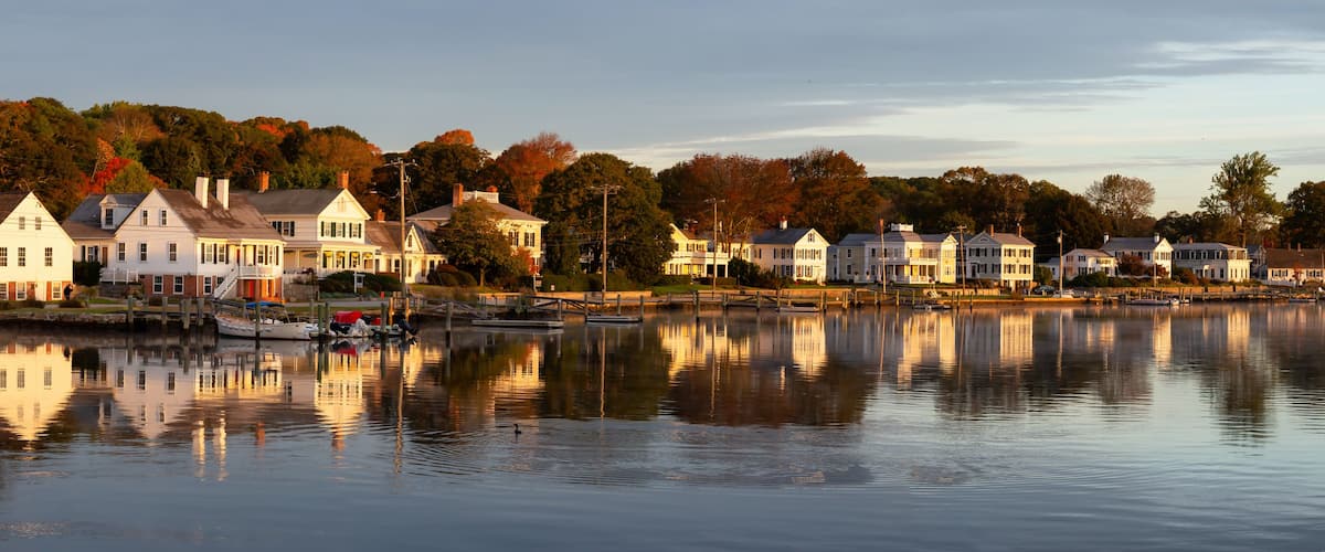 Panoramic view of residential homes by the Mystic River during a vibrant sunrise. Taken in Mystic, Stonington, Connecticut, United States.