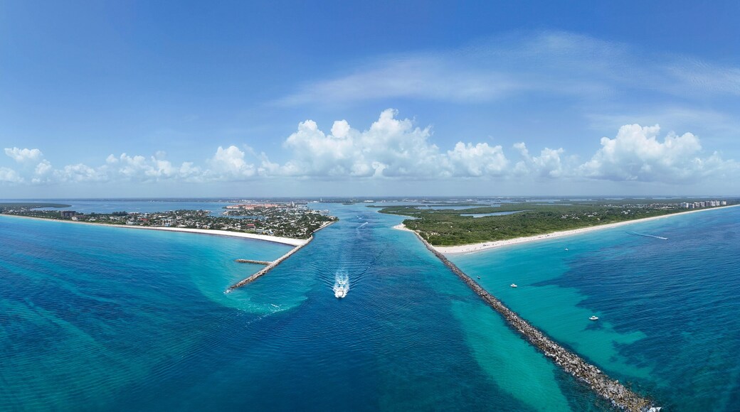 Aerial panorama view of boat heading to sea in Fort Pierce Inlet on the Treasure Coast of Florida in St. Lucie County