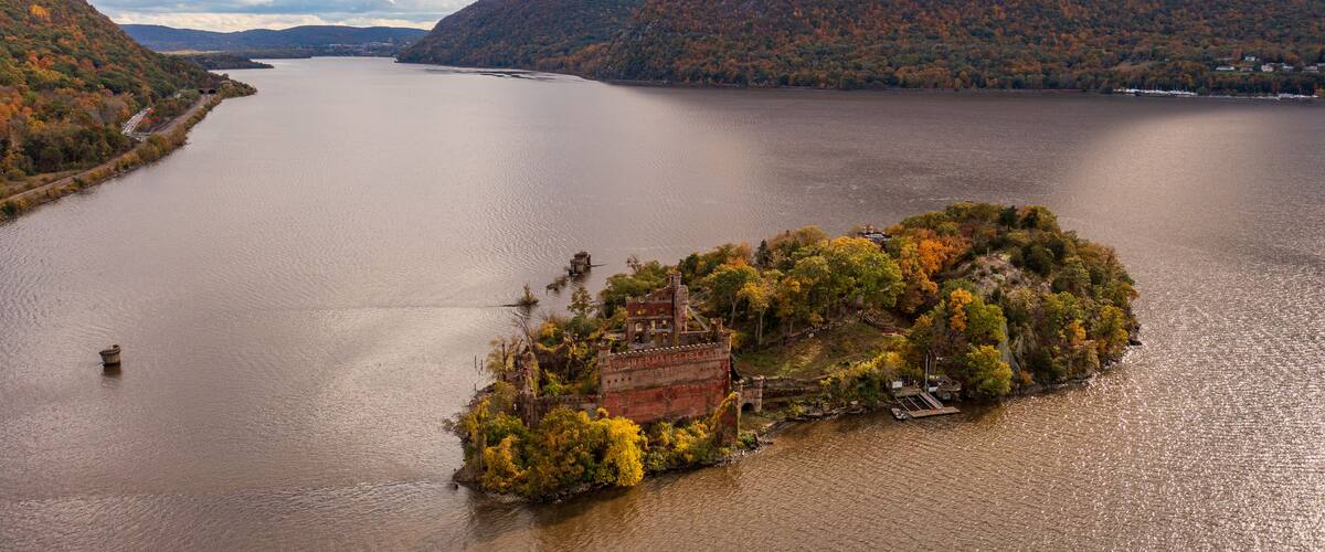 Aerial shot of the Bannerman's Castle on the Hudson River surrounded by hills in Dutchess County