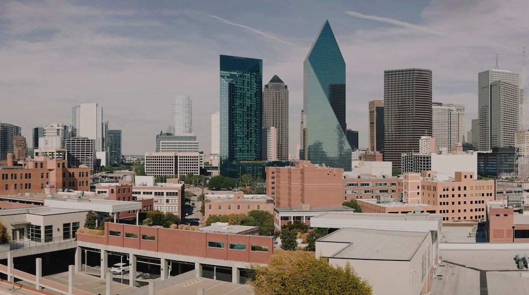Wide panorama of downtown Dallas skyscrapers under blue sky