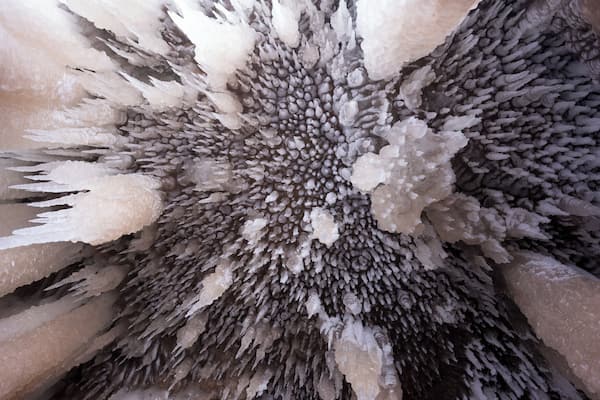 A close-up of a crystal formation with intricate branching structures.