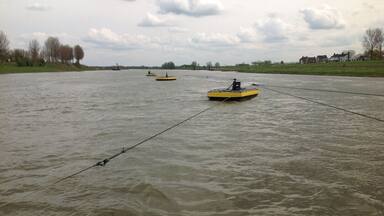 Three small boats connected by cables. Guess why.