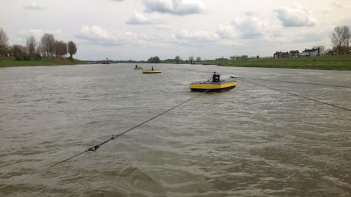 Three small boats connected by cables. Guess why.