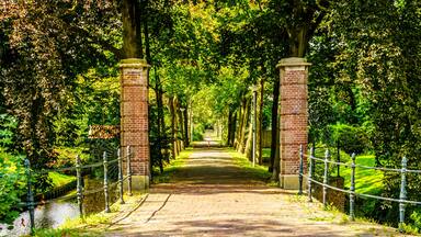 Brick Gate posts and tree lined lane into an Estate in the historic village of Midden Beemster in the Beemster Polder in the Netherlands